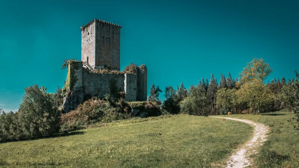 Beautiful shot of an old tower castle of the Andrade in the eume woods on a blue sky background
