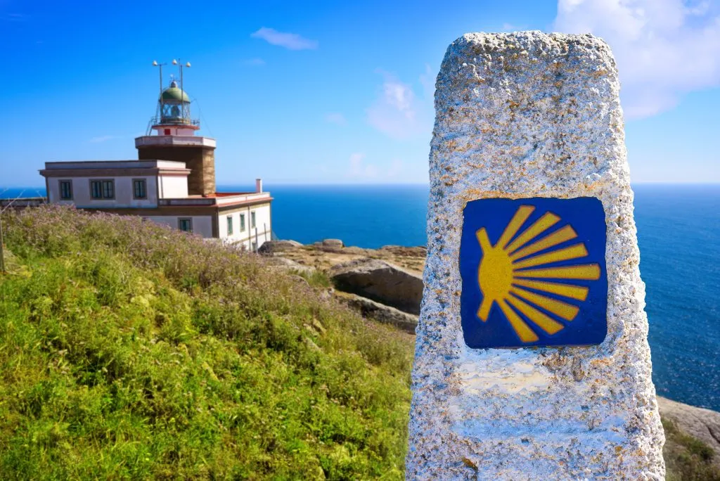 Saint James Way sign and lighthouse of Finisterre